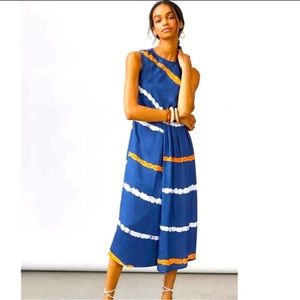 Navy sleeveless midi dress with orange and white designs.